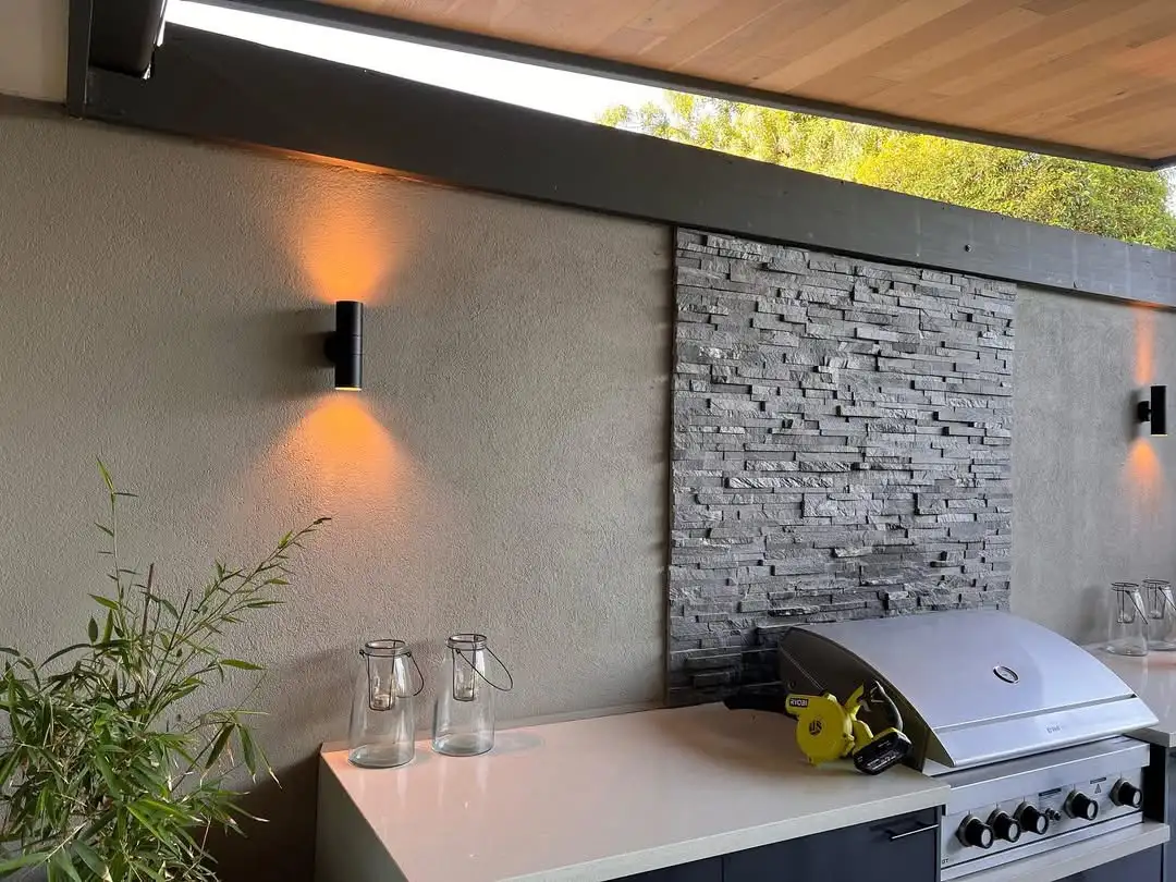 Outdoor alfresco lit by Ingot Electrics — warm up/down wall lights on a stone feature wall in Melbourne's north-east